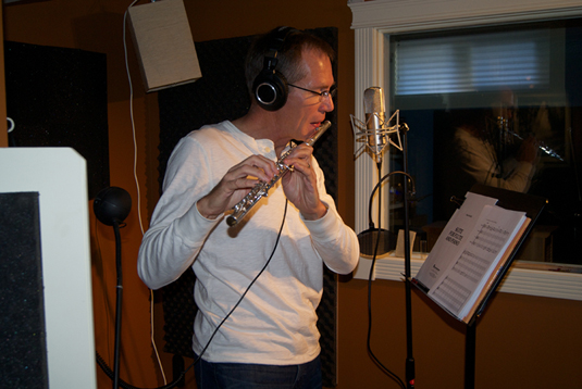 Duane playing the flute in his fully equiped studio.